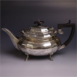 Early 20th century silver four piece tea service, comprising hot water pot, teapot, open sucrier and milk jug, each of part fluted oval form upon four stepped feet, the teapot and hot water pot with ebonised handle and finial, hallmarked Stephenson & Law, Sheffield 1918