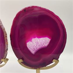 Pair of pink agate slices, polished with rough edges raised upon gilt metal stands, H20cm