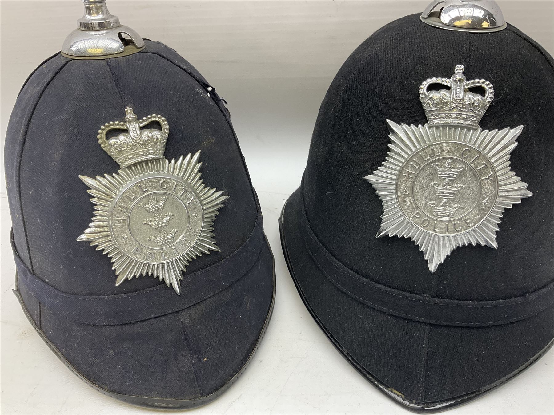 Hull City Police - helmet with king's crown night plate; two further ball-top helmets with Queen's crown plates; and a peaked cap (4)