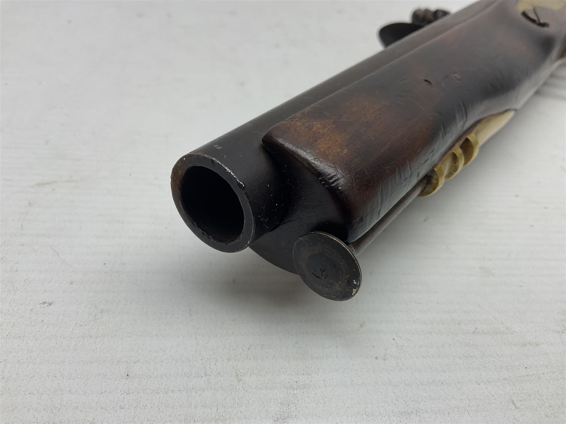 Modern non-firing reproduction Tower flintlock pistol marked with crowned GR and Tower to the lock, brass skull crusher butt and fittings L40cm overall; another Indian/Moorish reproduction flintlock pistol with mother-of-pearl inlay; and a modern die-cast replica Colt style revolver (3)