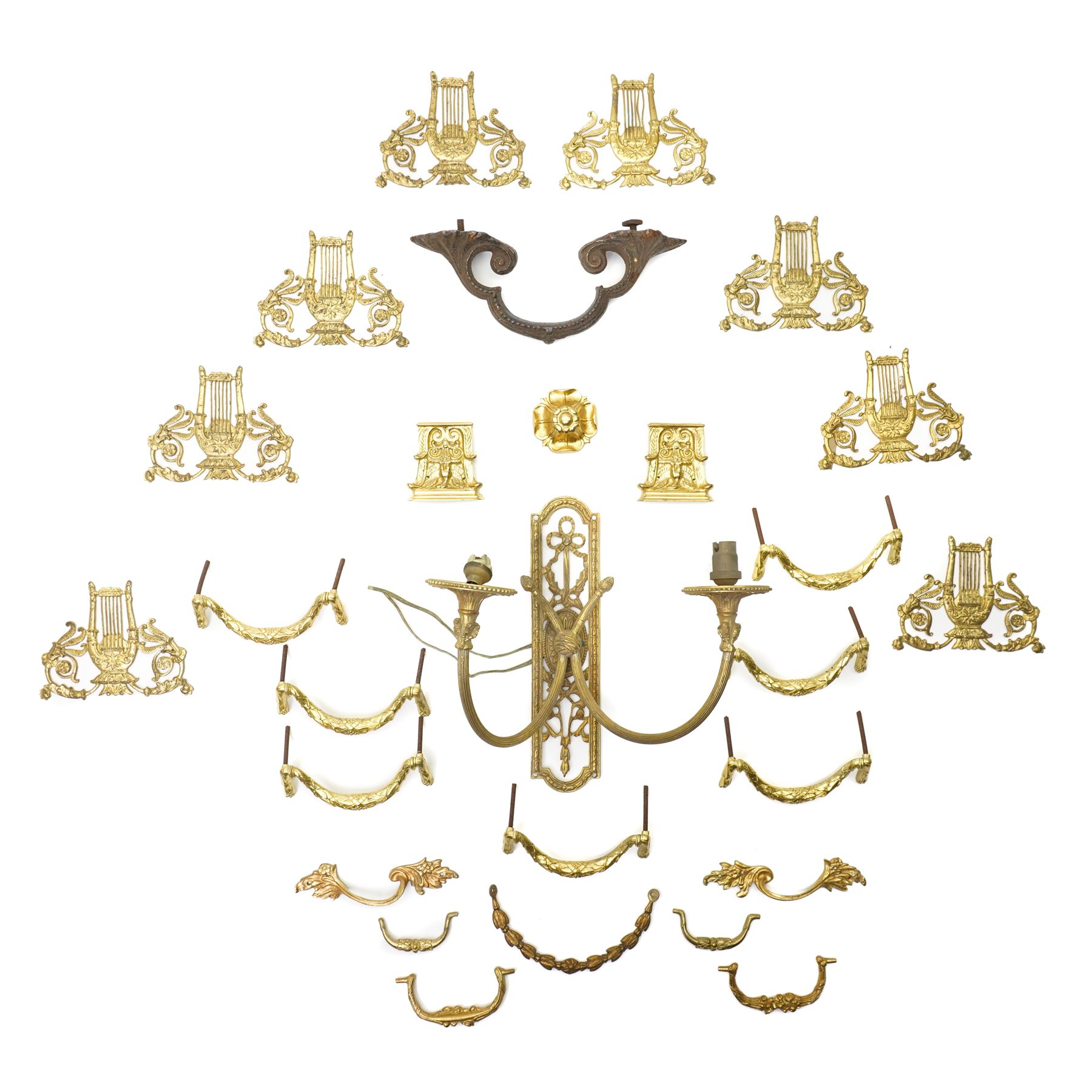 Set of eight brass cabinet door plates formed as lyres marked 'H.V' 9.5cm x 12cm, seven brass cabinet door handles of leaf design, various other handles, boss and a two branch wall light 
Provenance: property of a Nobleman