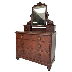 Victorian scumbled pine dressing chest, raised swing mirror in moulded frame with scrolled carved pediment, foliage S-scroll carved supports over trinket drawers, moulded rectangular top with rounded corners over two short and two long drawers, skirted base on turned feet, scumbled to resemble mahogany 