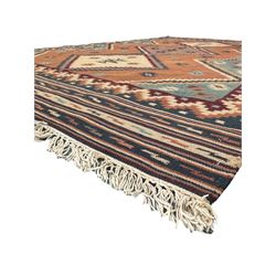 Flatweave rug, terracotta ground with multicoloured geometric diamond motifs, framed by a teal and burgundy border, finished with fringed edges