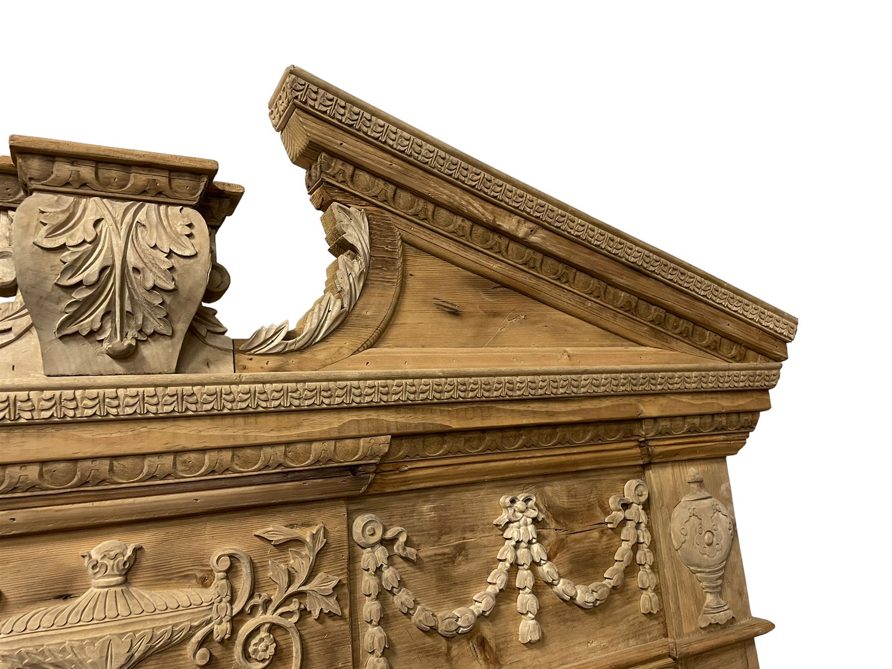 Large Adams design pine frame mirror, sloped broken arch pediment with central acanthus leaf carving, the frieze decorated with bell flower garlands and central kylix vase motif, large plain mirror plate flanked by panelled sides with egg and dart mouldings and reeded slip mouldings, on plinth base