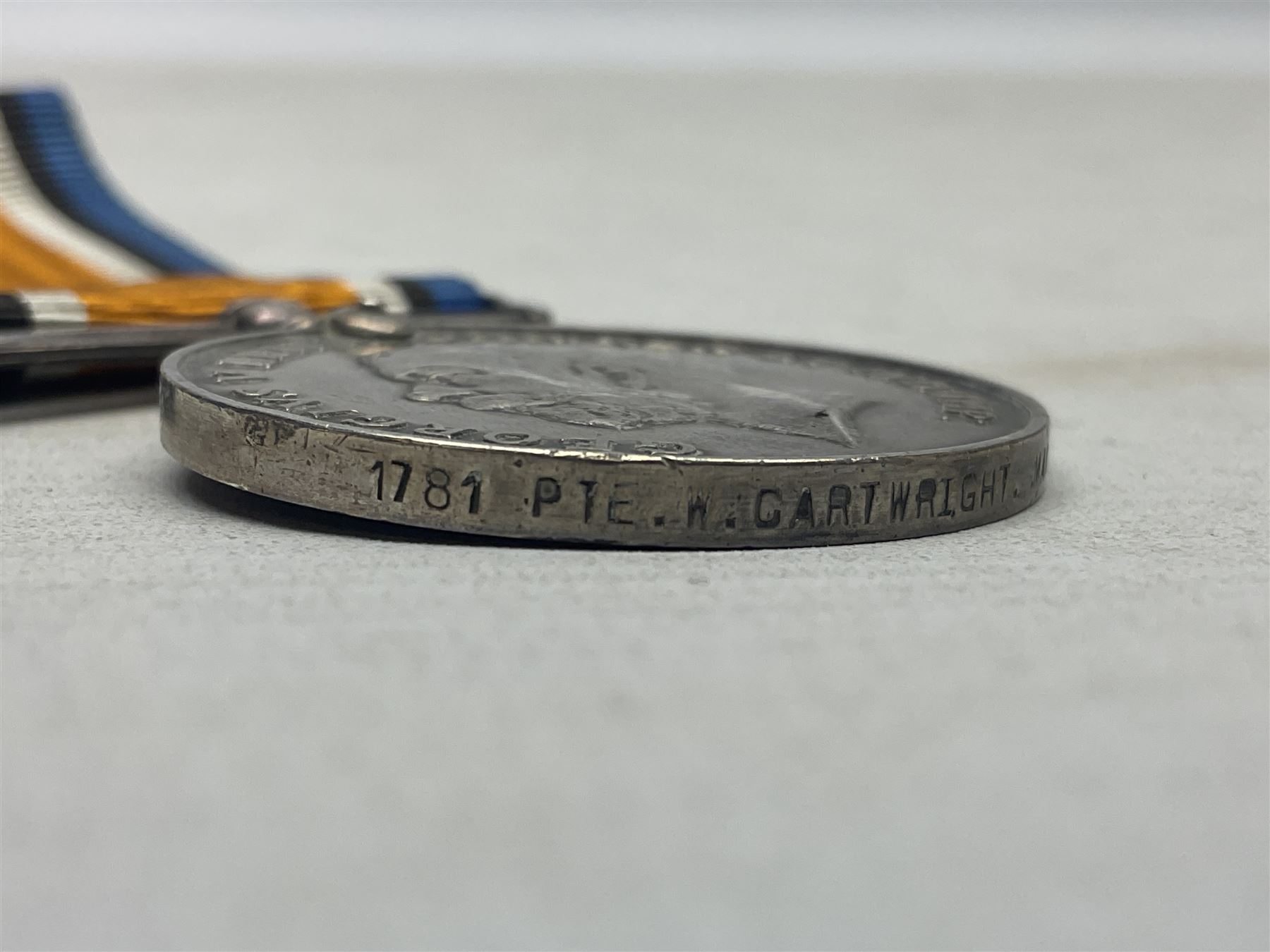 WW1 group of three medals comprising British War Medal, 1914-15 Star and Victory Medal awarded to 1781 Pte. W. Cartwright Manch. R.; and another WW1 British War Medal awarded to 30284 Pte. W.H. Paterson Manch. R.; all with ribbons (4)
