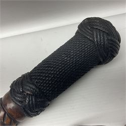 19th century wooden walking stick, the handle carved as a snake within a clenched fist, the cane carved with foliate and cross hatched decoration, with a metal spike to base, together with a turned wooden walking stick, with lacquered rope nautical knot handle, tallest L96.5cm