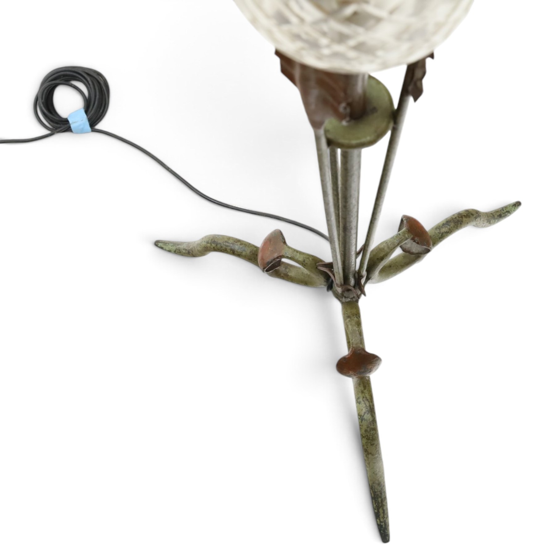 Arts and Crafts wrought iron and copper standard lamp, the openwork stem centred by a cut-glass reservoir with arrow-cut decoration, applied with stylised copper leaves, on shaped tripod base