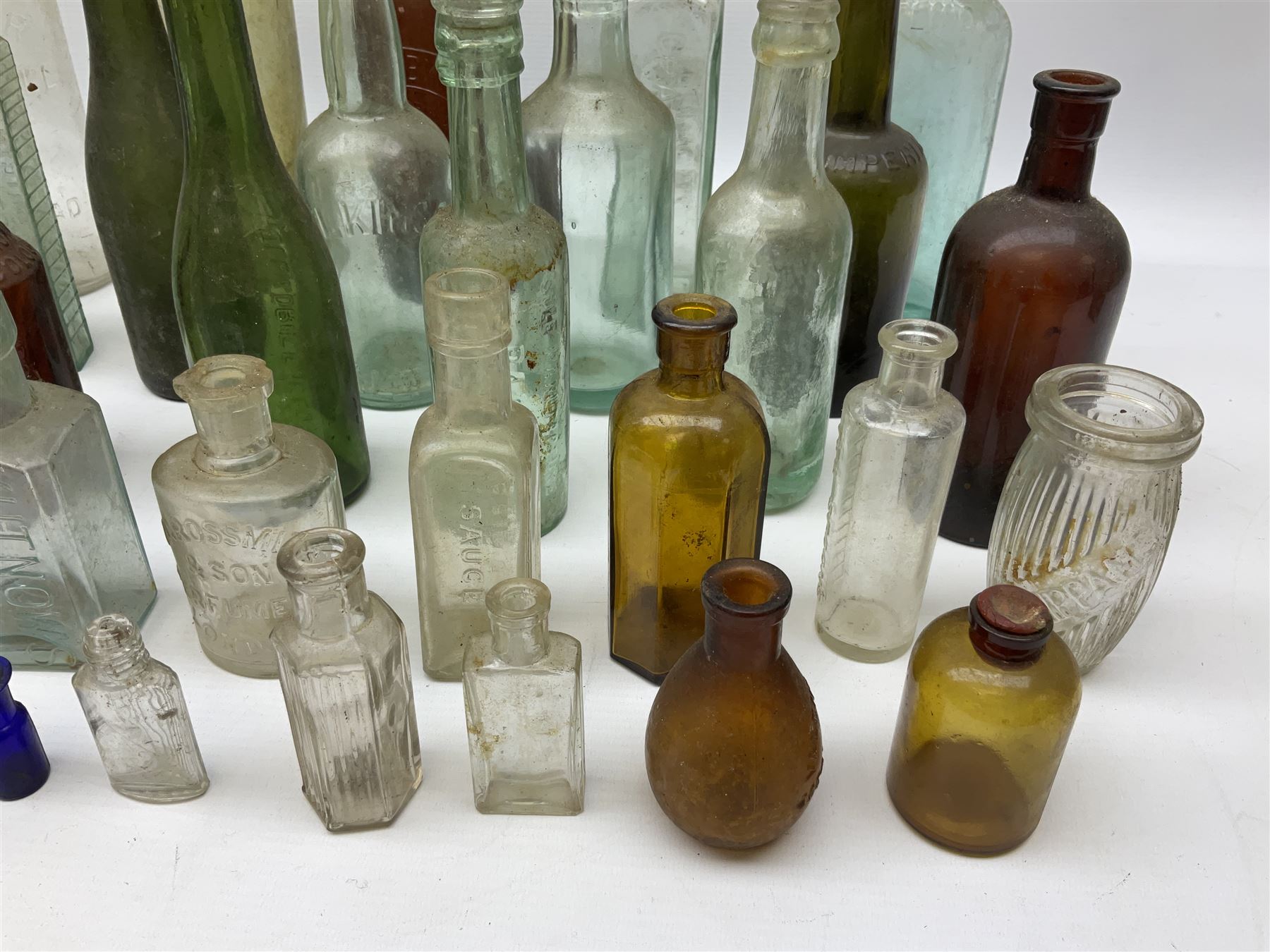 Collection of various vintage glass bottles and stoppers, including advertising bottles, sauce bottles and medical bottles etc