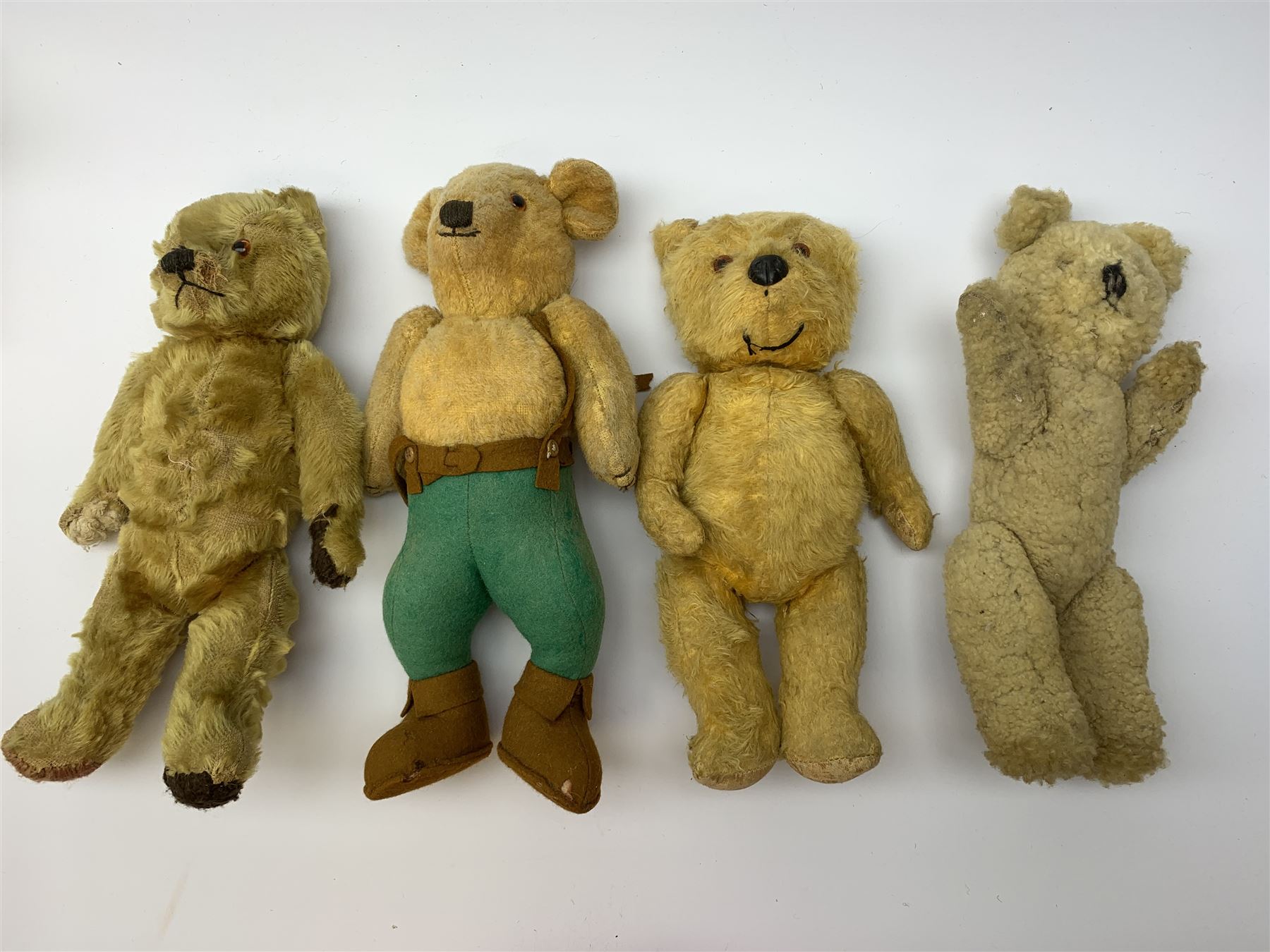 Nine English teddy bears 1950s-60s including wood wool filled Pedigree bear with swivel jointed head, glass eyes, vertically stitched nose and mouth and jointed limbs H14.5