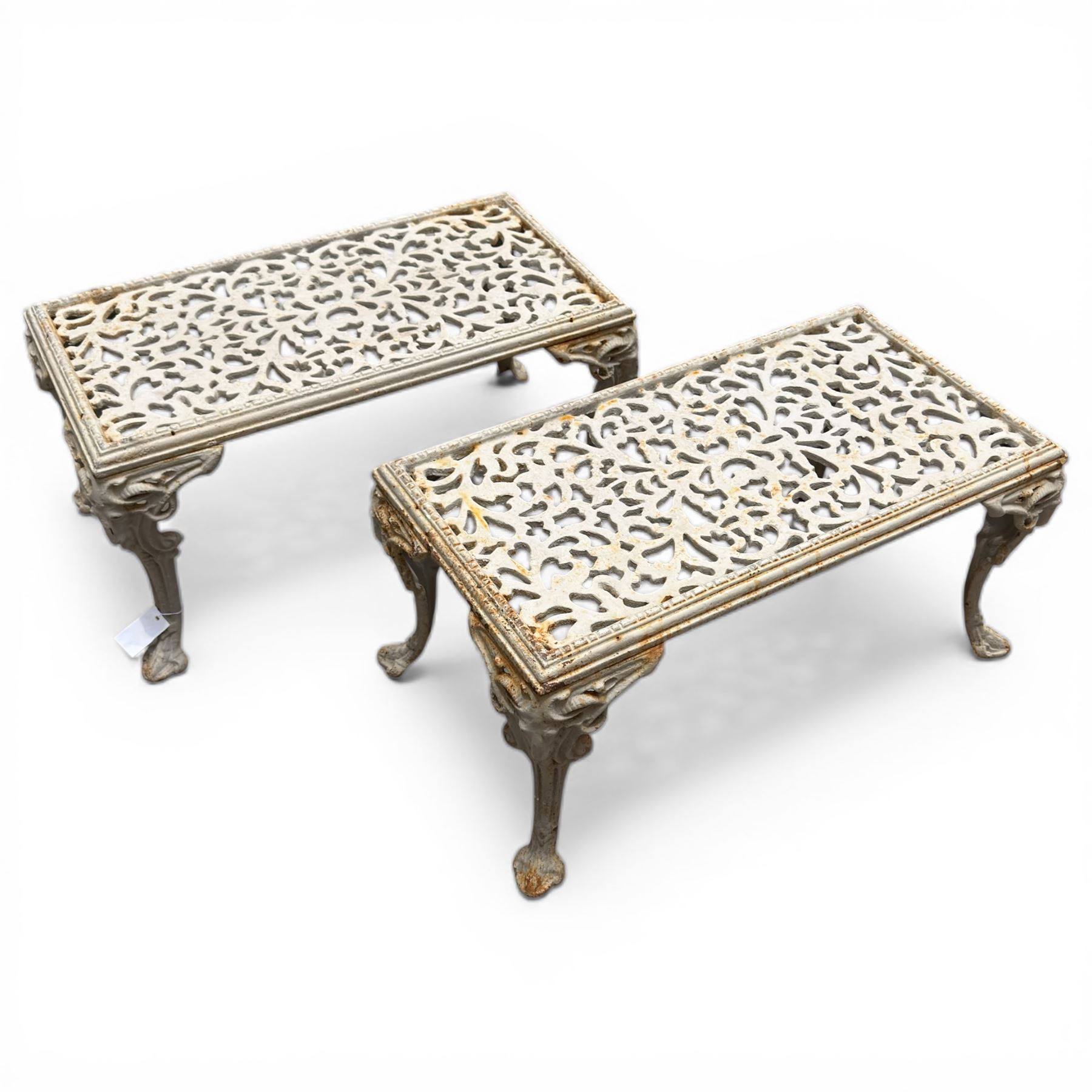 Pair of cast iron low garden tables with rams head legs in a white finish