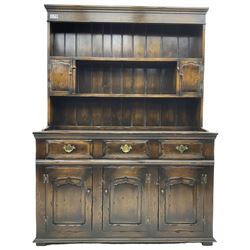 Georgian design oak dresser, the two-tier plate rack with two flanking spice cupboards, the base fitted with three drawers over three arched fielded panelled cupboards, lower moulded edge on block feet