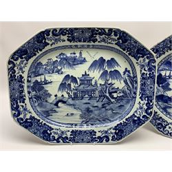 Pair of late 18th/early 19th century Chinese export blue and white platters, of canted form, decorated with landscape set with typical motifs including two figures upon a bridge, temple, and pagoda and huts upon islands, within cell diaper and scrolling foliate borders, W46cm 