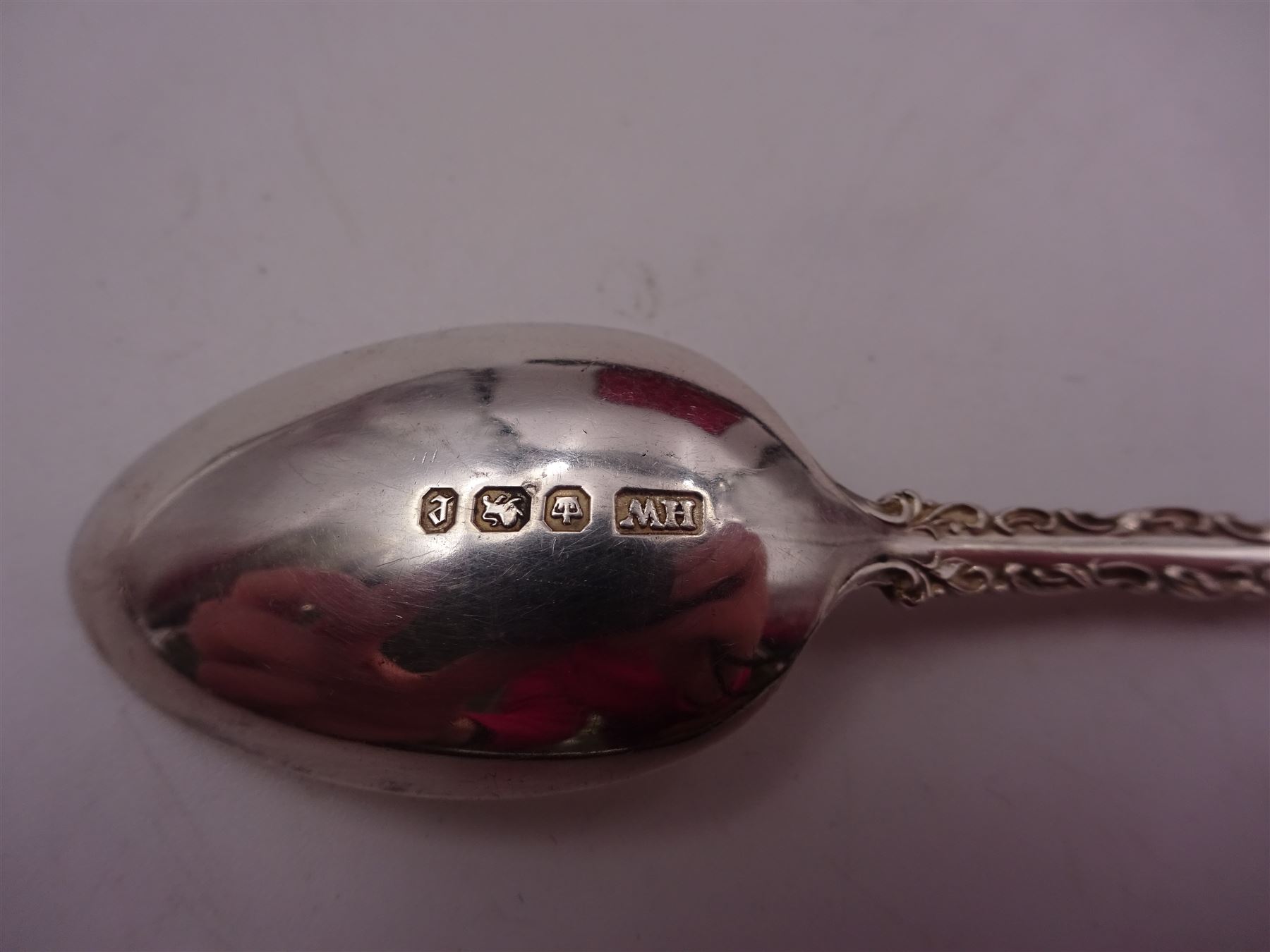 Set of ten Victorian silver coffee spoons, each with shaped scroll design rim, and a matching pair of sugar tongs, hallmarked Lee & Wigfull, Sheffield 1897, in tooled leather burgundy velvet and silk lined fitted case 