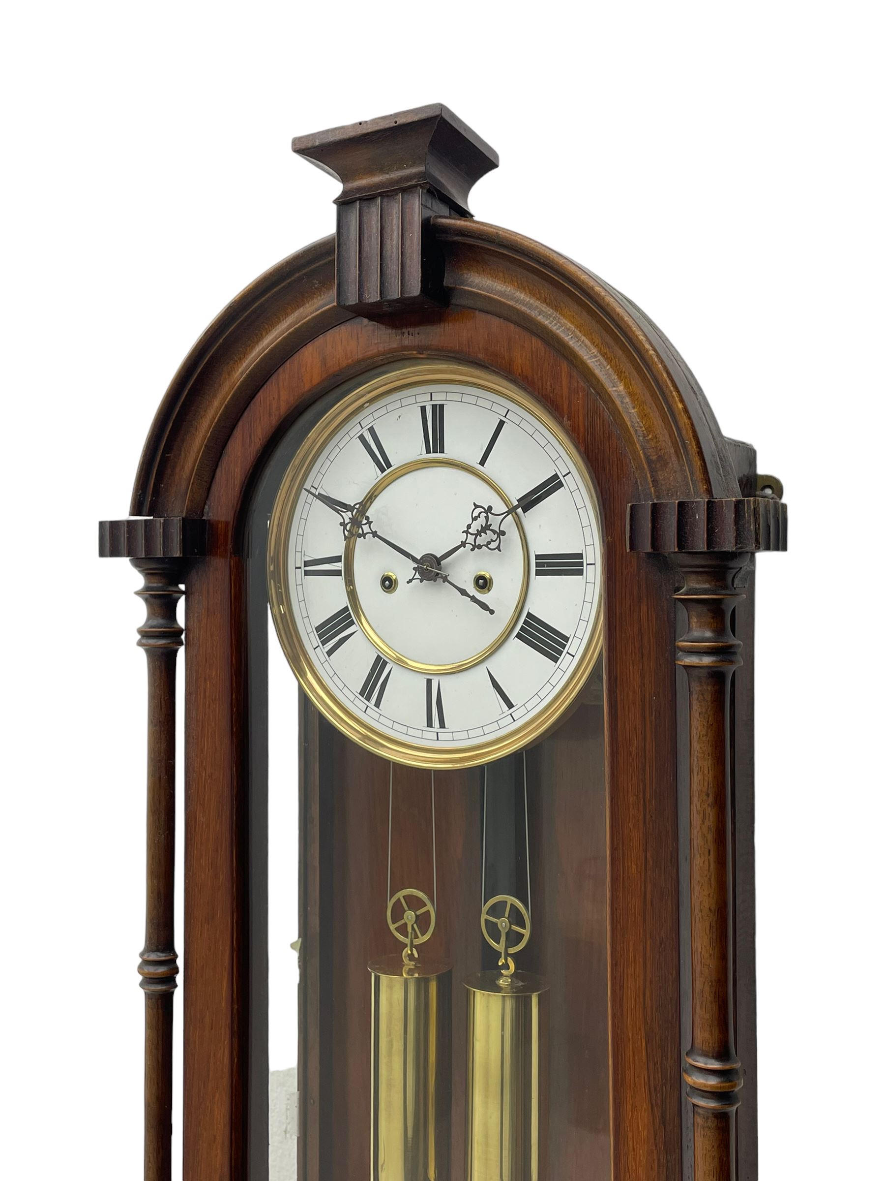 Lenzkirch – 8-day walnut cased weight driven Vienna regulator manufactured 1877-1878, with a break-arch pediment surmounted by a turned finial on a raised cavetto molding, fully glazed arched  door flanked by long ring turned pendants, flat base with open fretwork and two short pendants,  two piece enamel dial within a brass slip, Roman numerals, minute track and pierced steel hands, wooden pendulum with a brass faced bob, two brass cased weights and pulleys, dead beat escapement with a rack striking movement sounding the hours and half hours on a coiled gong, movement serial number 421410. 
Lenzkirch were one of Germanys most highly respected clock manufacturers of the 19th century, founded in the late 1850s the company produced movements and cases of high quality up until 1932.
