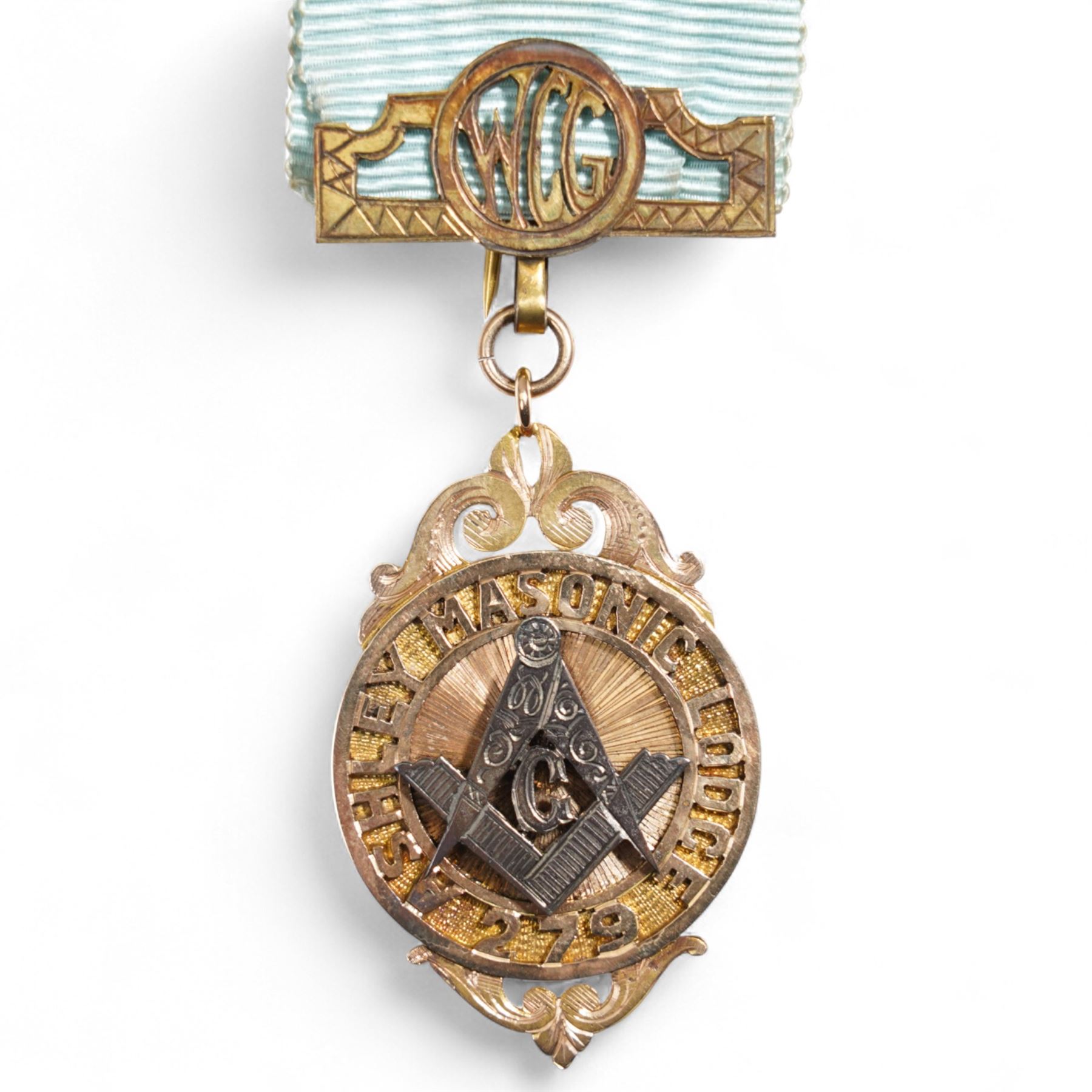 Early 20th century gold presentation Masonic jewel,  'Ashley Masonic Lodge 279', stamped 9ct, with applied silver emblem, on gilt mounted ribbon, the reverse with inscription 'Presented to John Gray 1929'