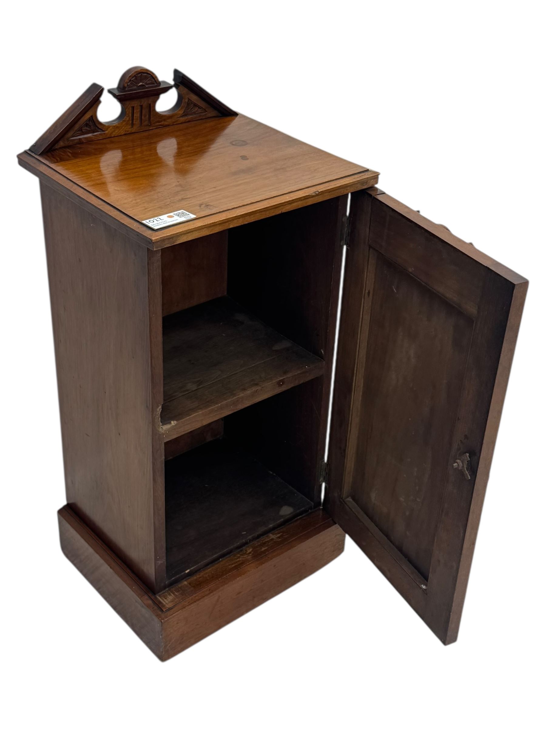 Victorian walnut bedroom suite - wardrobe, dressing chest and bedside cupboard, comprising a full-length wardrobe with broken pediment and central mirrored door, large lower drawer, a matching dressing table with bevelled swing mirror over two trinket drawers and two short drawers over two long drawers, and a single-door bedside cupboard, all with moulded edges, decorative panel work and shaped aprons