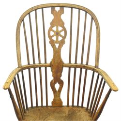 Set of two late 19th century elm and beech Windsor armchairs, each with hoop backs and turned spindles, shaped central splats, solid seats and turned supports united by H-stretchers