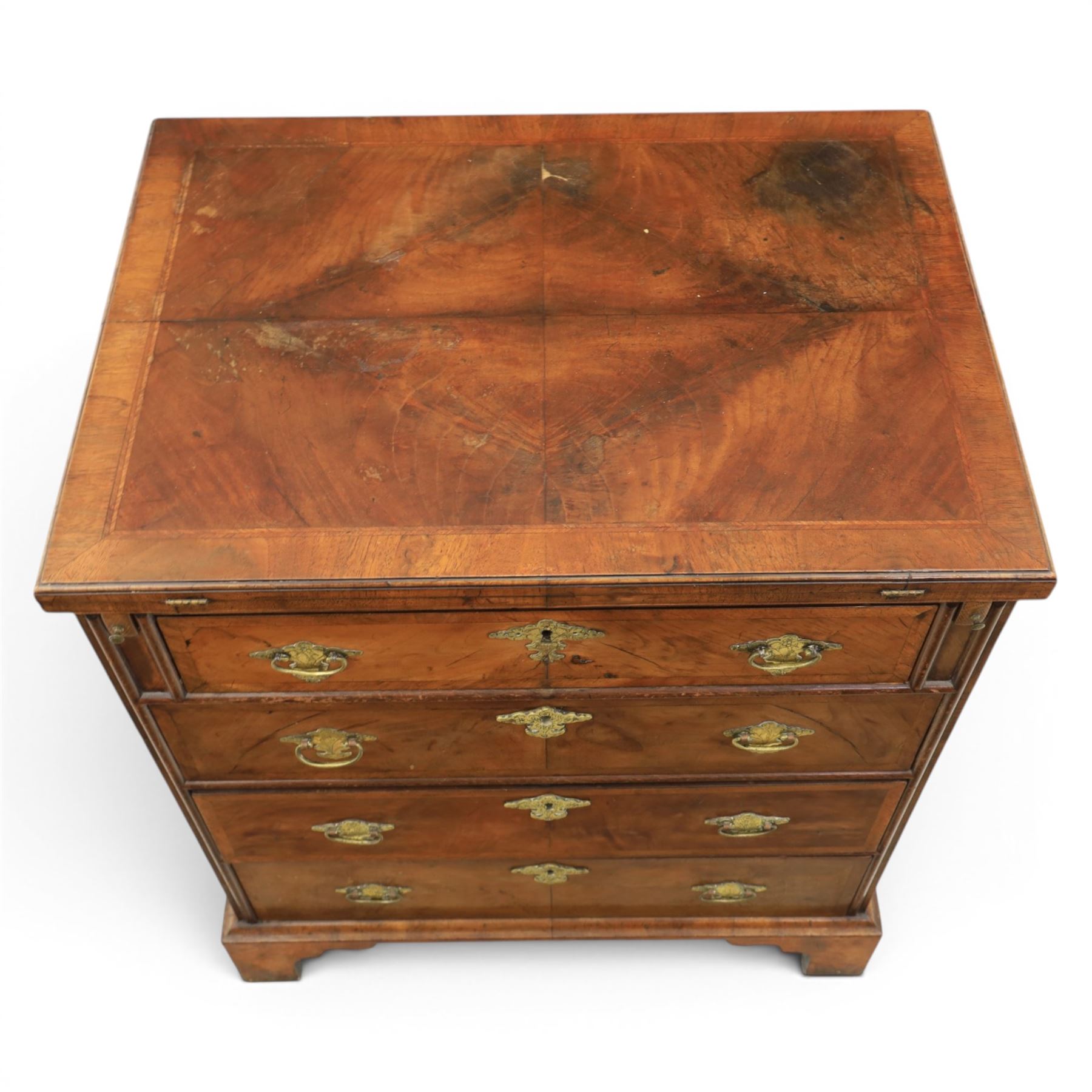 Early 20th century Georgian design figured walnut bachelor's chest, with half fold over top and lopers, over three drawers with pierced brass handles and escutcheons 