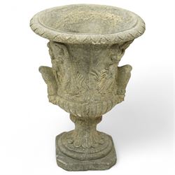 Late 20th century set of four composition stone campana urns, each with everted rim over acanthus and mask relief decoration, tapering to a fluted socle on square plinth base