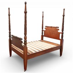 Early 19th century Regency carved mahogany four poster double bed, 4'6, the shaped headboard and footboard each surmounted by a finely carved pinecone and foliate moulded rail, flanked by ring turned and boldly spiral carved tapering posts with acorn finials, raised on square section legs, with slatted base