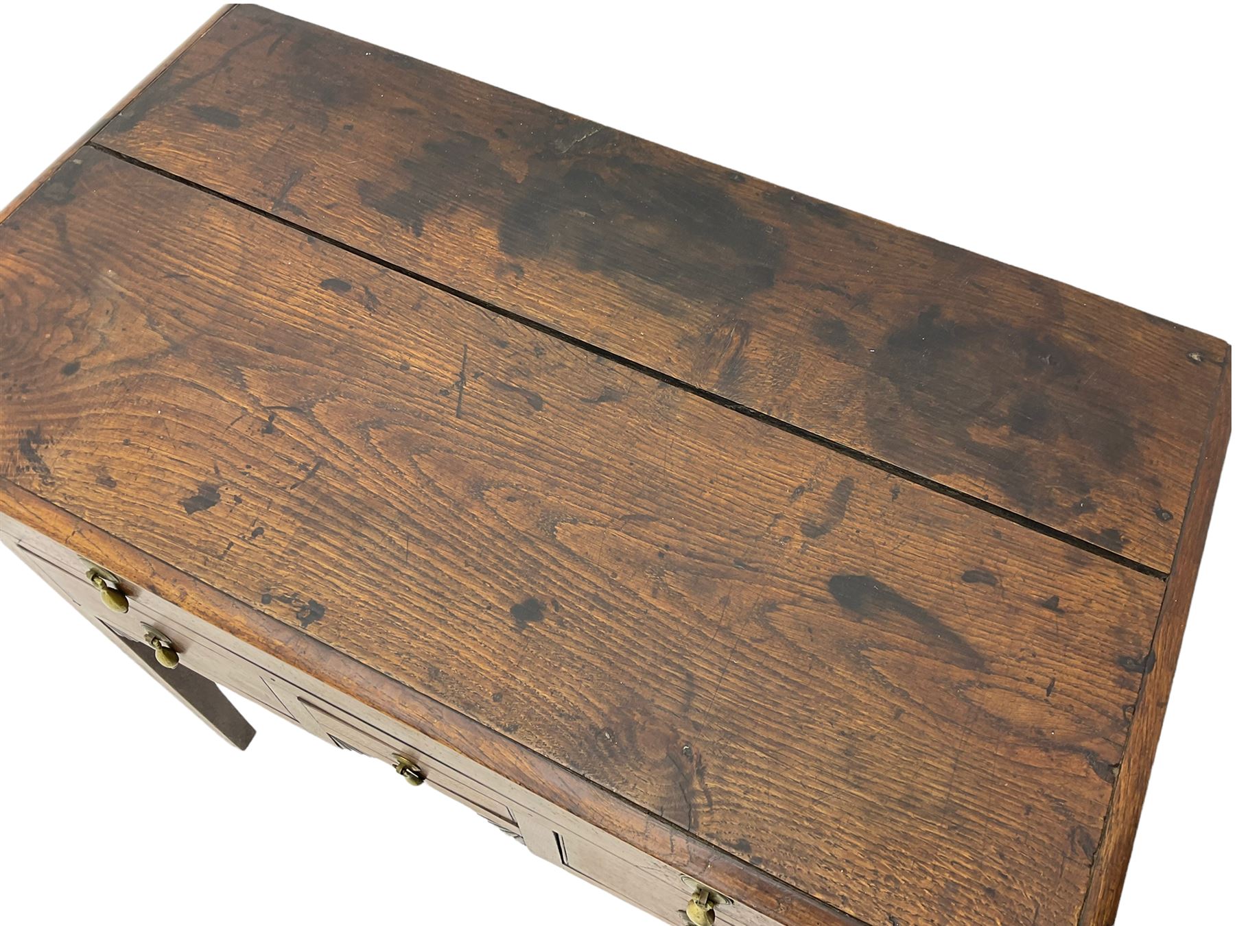 18th century Welsh oak lowboy, fitted with long drawer above three small drawers, square tapering supports, with fan carved corner brackets, circular plate and drop handles 