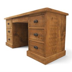 Indigo Furniture - rustic oak twin pedestal desk, rectangular plank top, with central frieze drawer, the fixed pedestals with three drawers and metal cup handles, raised on a plinth base
