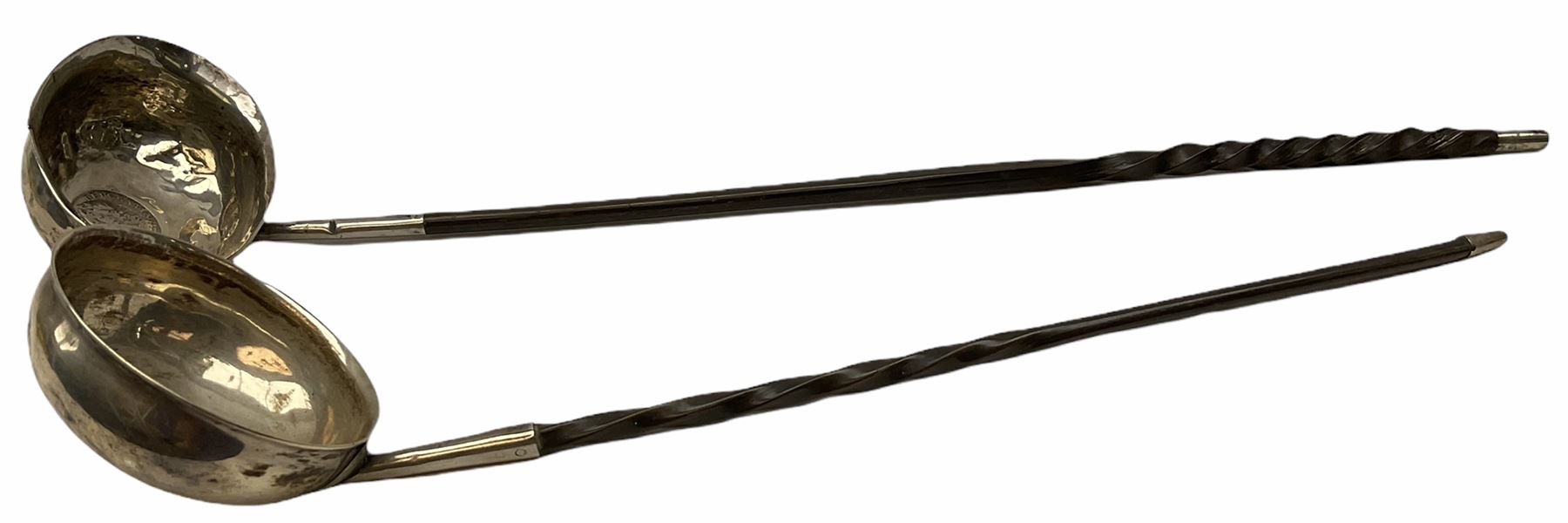 Two Georgian silver toddy ladles with baleen twist handles, (neither hallmarked), one with inset coin to bowl, together with a group of silver plate including cruet stand enclosing two glass bottles with stoppers, shaker and preserve pot with spoon, pair open salts with glass liners, etc. 