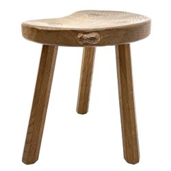 'Mouseman' oak three legged stool with dished kidney shaped seat, tapered octagonal supports, with carved mouse signature, by Robert Thompson of Kilburn 