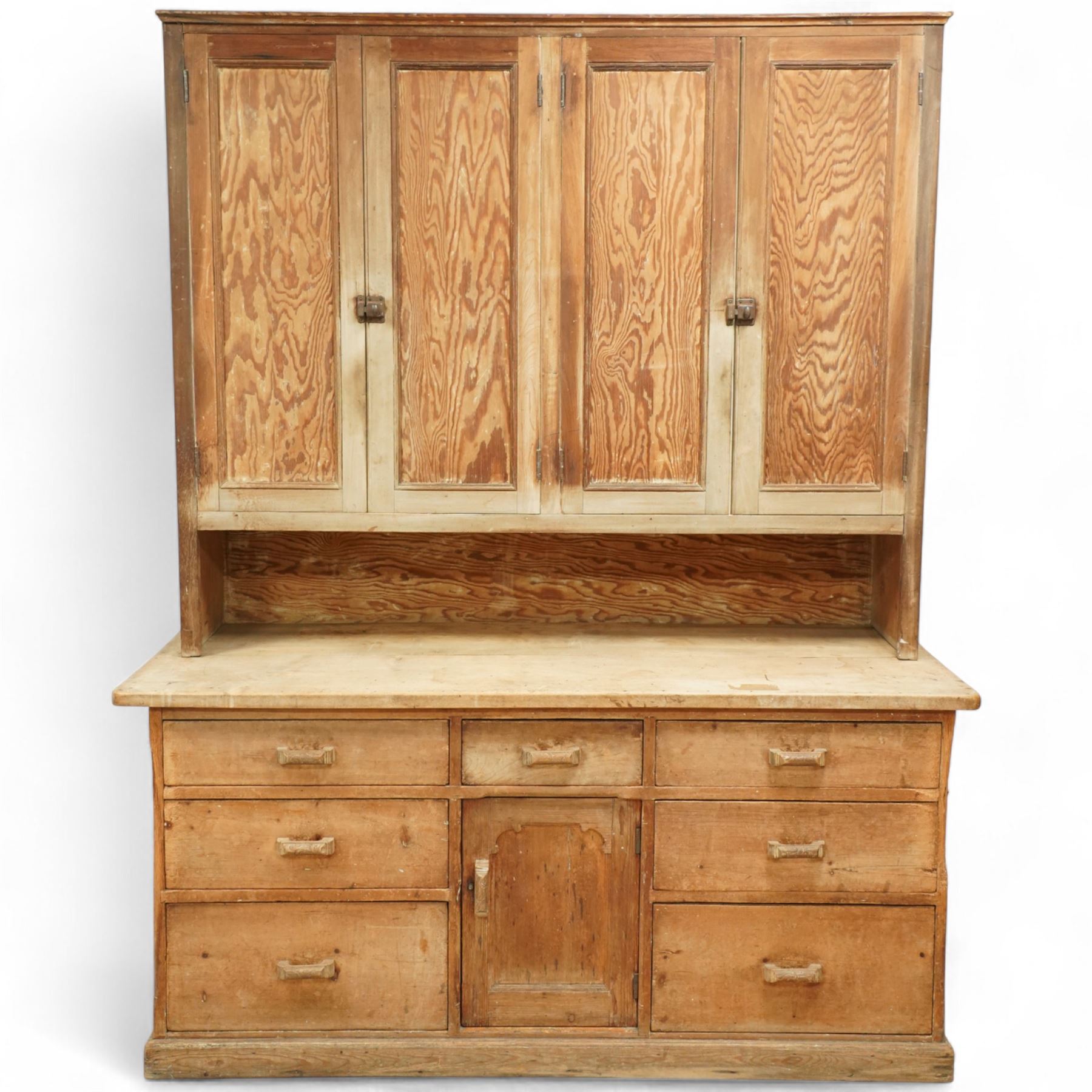 Early 20th century pine and beech kitchen dresser, projecting cornice above three panelled cupboard doors, base fitted with three drawers and twin panelled cupboards, on plinth base