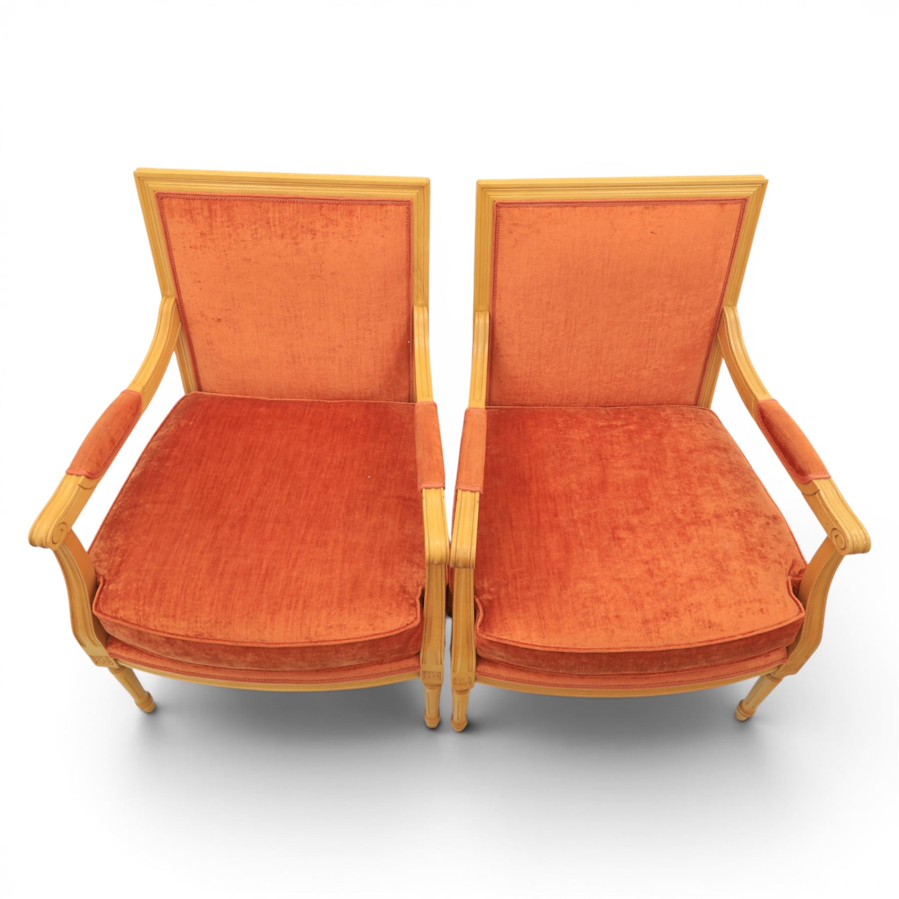 Pair of mid-20th century beechwood fauteuil armchairs, upholstered backrest and seat in terracotta velvet fabric, padded armrests with scroll detail, on tapered fluted supports with carved floral rosette blocks (very modern and not a desirable timber)