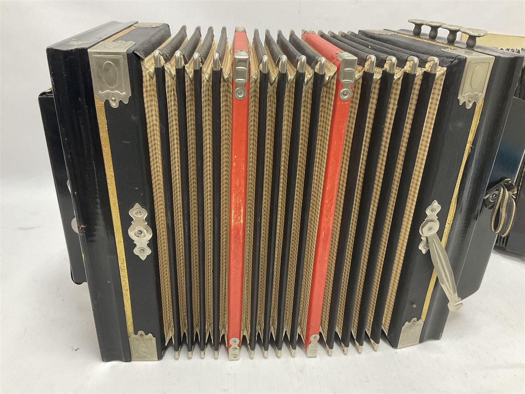 Three European concertinas, comprising Viceroy German concertina with 21 keys, hexagon wooden frame and 8 fold bellows
Oak framed concertina with 12 keys and 8 fold bellows
Commander concertina with 12 keys and 12 fold bellows
With tutor