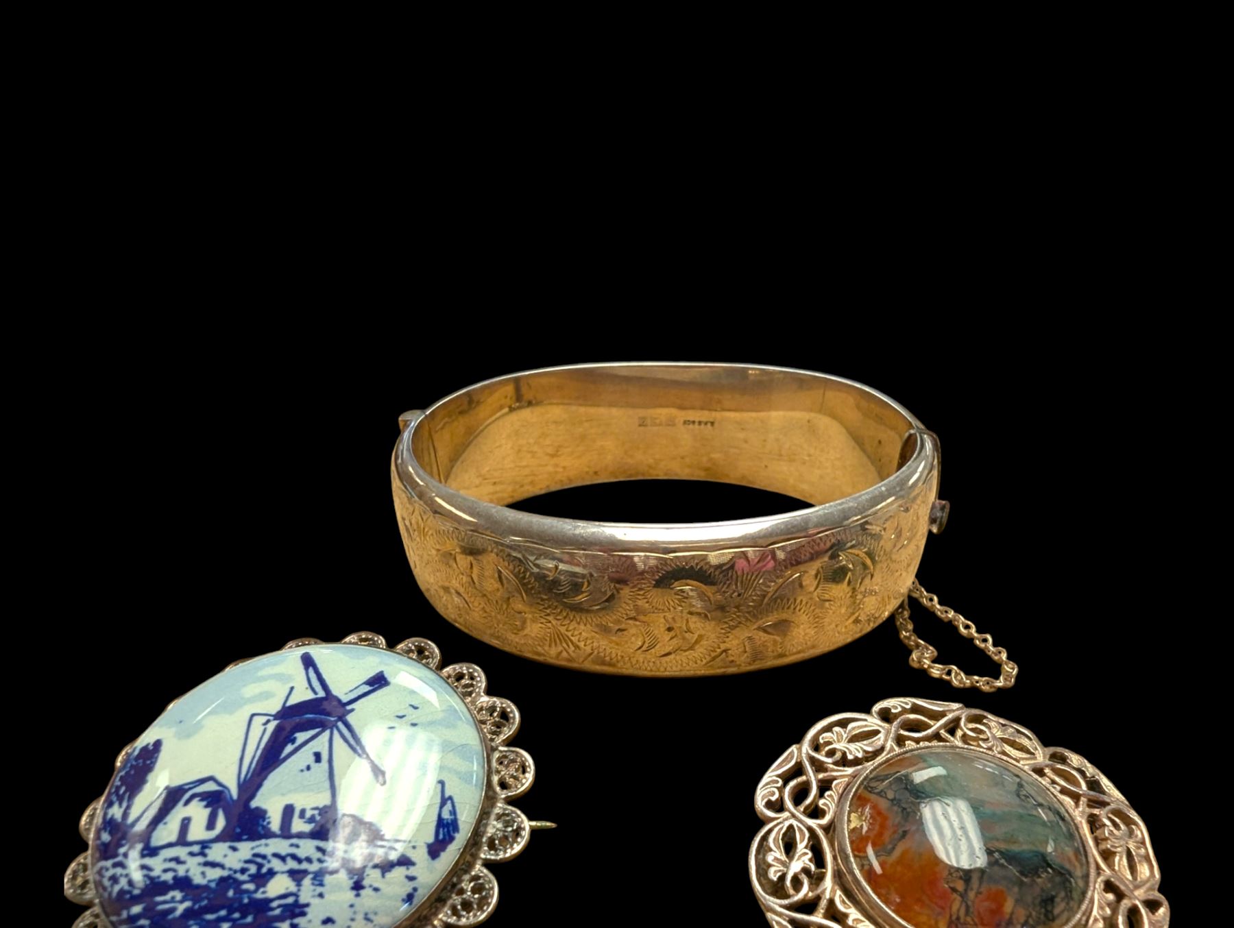 Silver bangle with four silver brooches