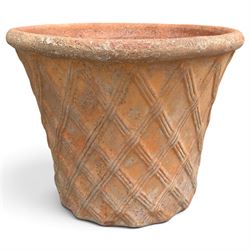 Terracotta pot of generous proportions with rolled rim and lattice design in relief