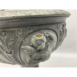 Victorian cast spelter oil lamp, decorated with cherubs and foliate scrolls, supporting a glass reservoir, burner and clear glass chimney, H62cm