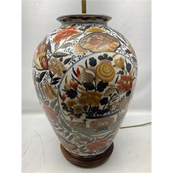 Pair of large and impressive 20th century Japanese Imari table lamps, each of ovoid form, decorated in the Imari palette with roundels containing flowering urns, and shaped panels of birds, set against a white ground decorated with blossoming peonies, lamp base (not including fixtures) H56.5cm overall including shade H89cm