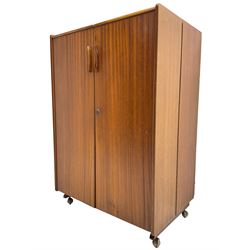 Mummenthaler & Meier - mid-20th century circa. 1960s teak 'Magic Box' folding desk cabinet, the cabinet opens to reveal shelves, writing desk, document holders and lamp, on castors