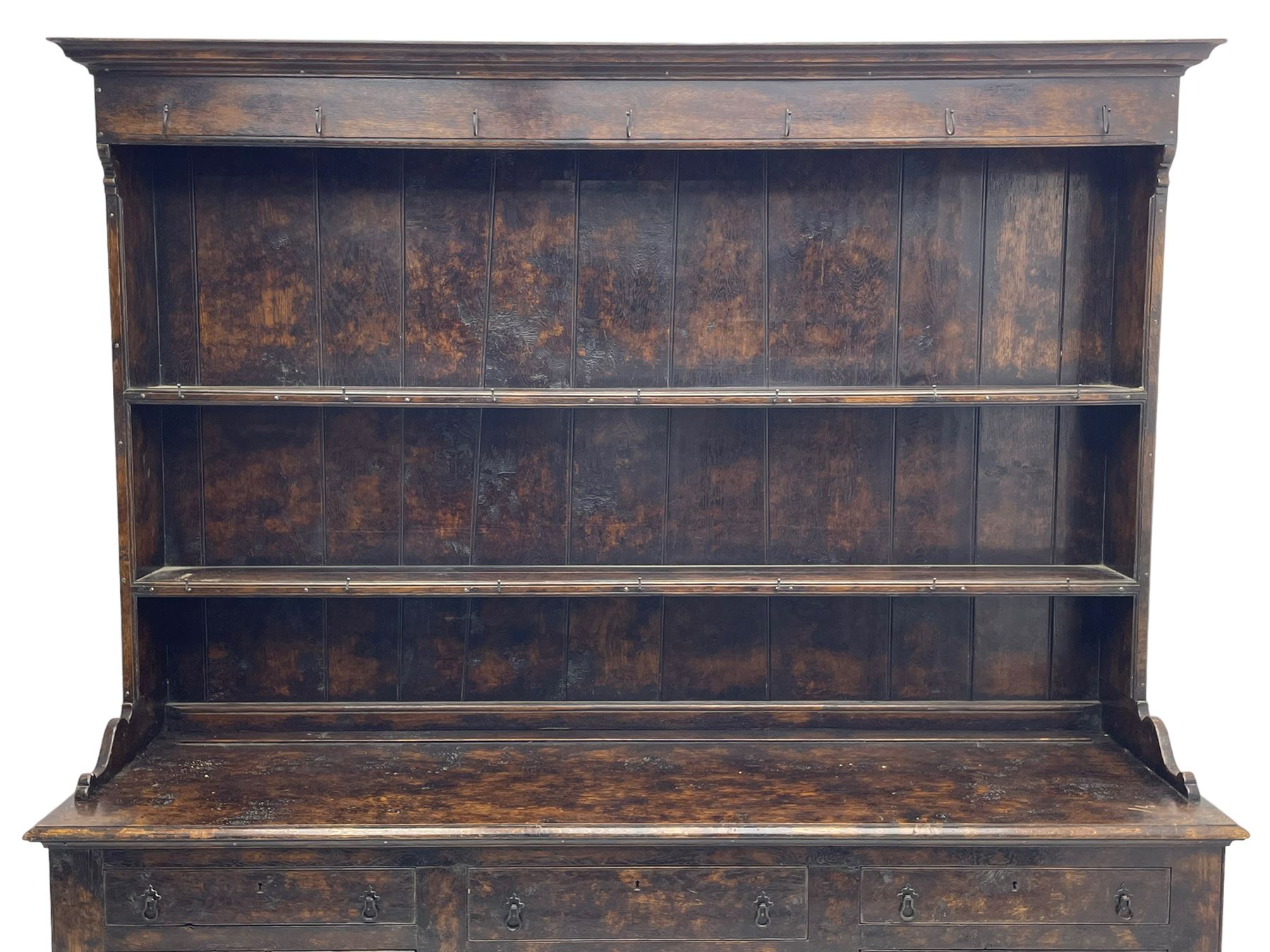 Bylaws of Leominster - 18th century design figured oak dog kennel dresser, the raised plate rack with projecting cornice over hooks and three tiers, moulded rectangular top over three drawers and two panelled cupboards, moulded frame and panelled sides, on stile supports