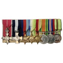 WW2 Royal Naval group of eight medals comprising OBE, hallmarked silver Distinguished Service Cross inscribed verso Lieut. J.R. McCluskie RNVR 1945, 1939-1945 Star, Atlantic Star, Africa Star, 1939-1945 War Medal, Defence Medal and Royal Naval Patrol Service Medal inscribed Lieutenant J.R. McCluskie Royal Naval Patrol Service; with seven original photographs of a sea battle 27th November 1940 against the Italian Fleet and another photographic postcard of Sir Stafford Cripps arriving on board one of the vessels.