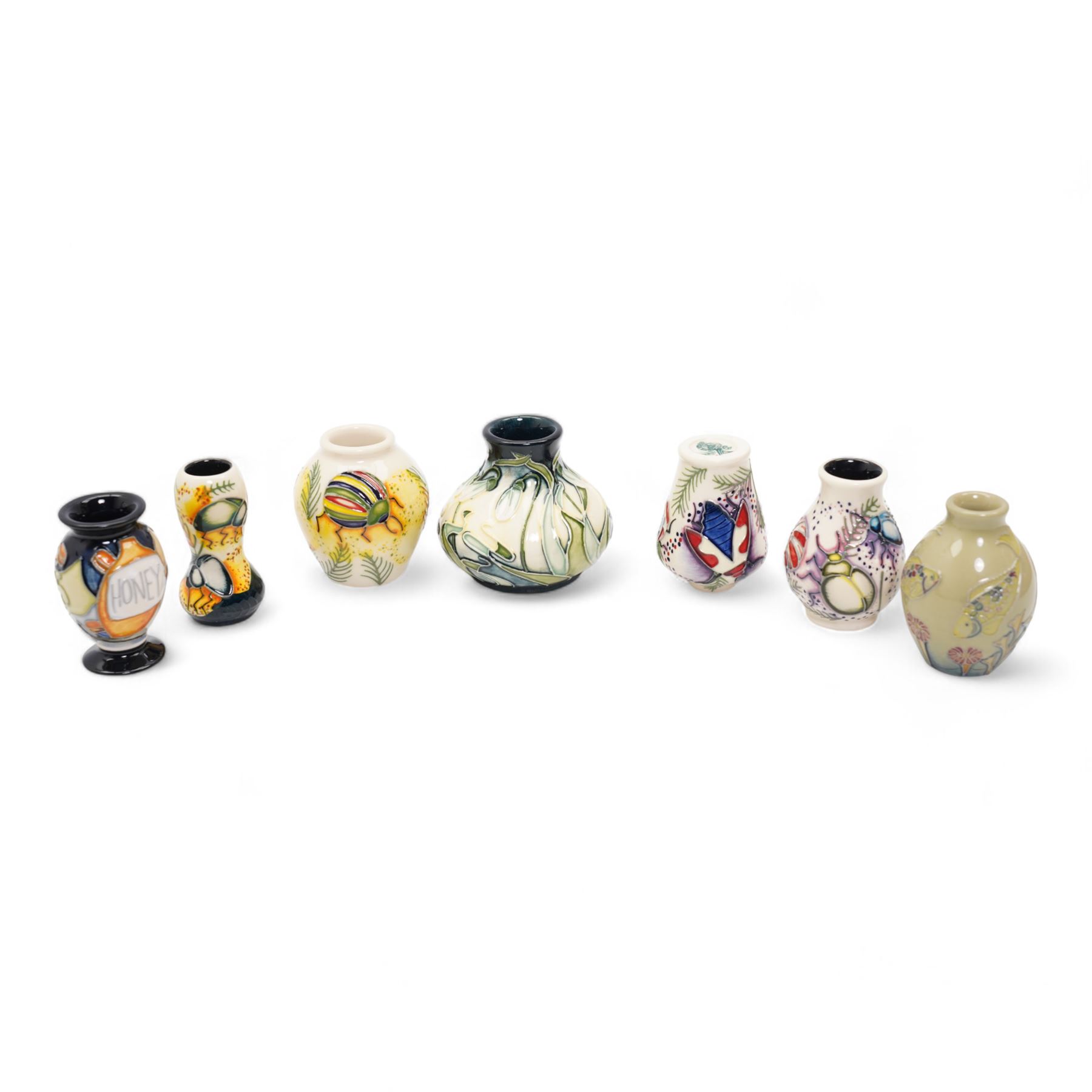 Seven Moorcroft miniature vases, various patterns including snowdrops, beetles, insects, cat fish etc, H6cm max (7)