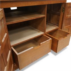  Beaverman - oak media cabinet, rectangular top with interictally carved panels to the side and front doors, twin doors with Yorkshire Rose carved wooden knob, enclosing a staggered shelf arrangement above two drawers, raised on a moulded plinth base, with carved beaver signature, by Colin Almack of Sutton near Thirsk