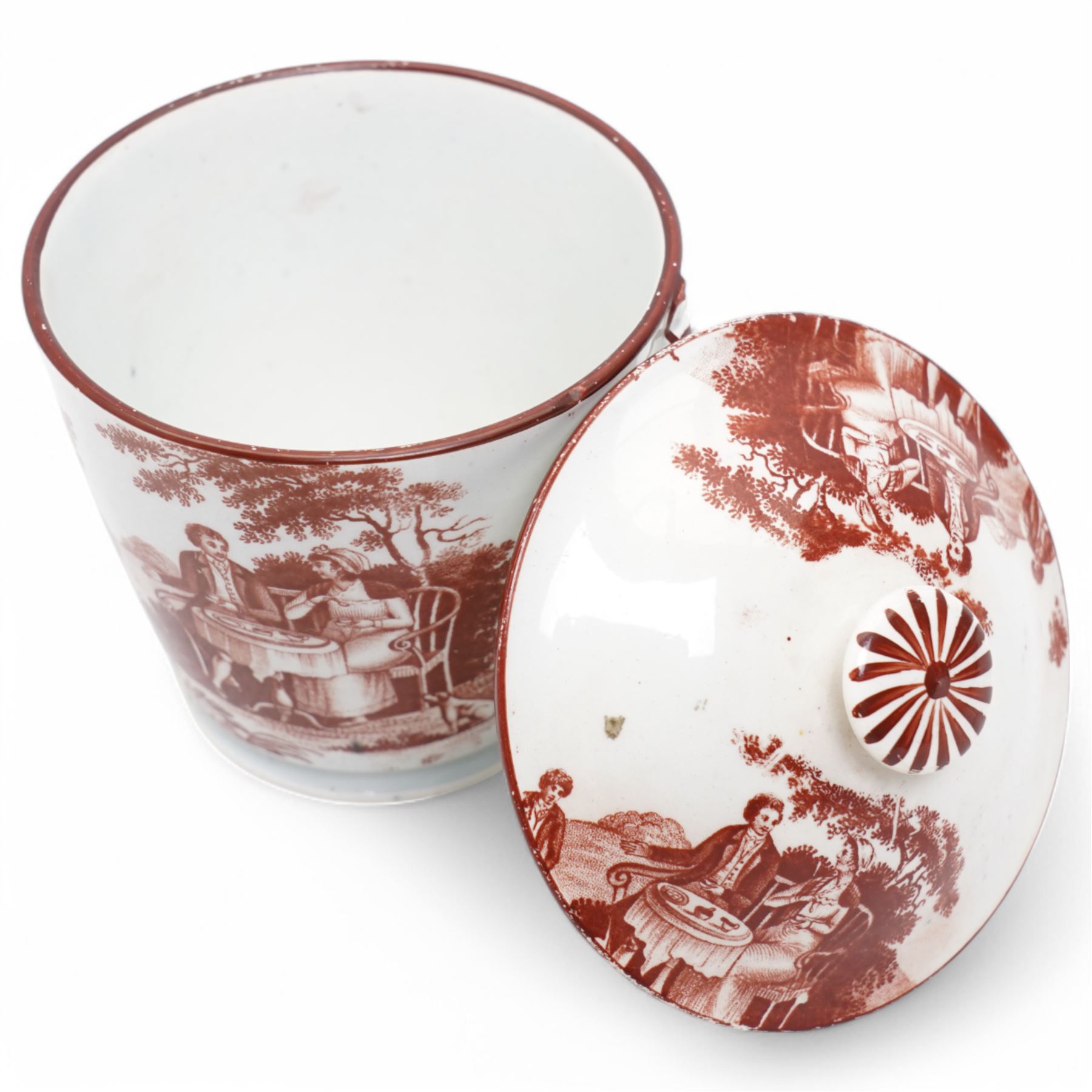 Early 19th century cream pail and cover printed in terracotta with figures sitting in a garden taking tea and with faux loop handles, with old label to the base 'Shorthose & Co. Staffordshire' H9cm