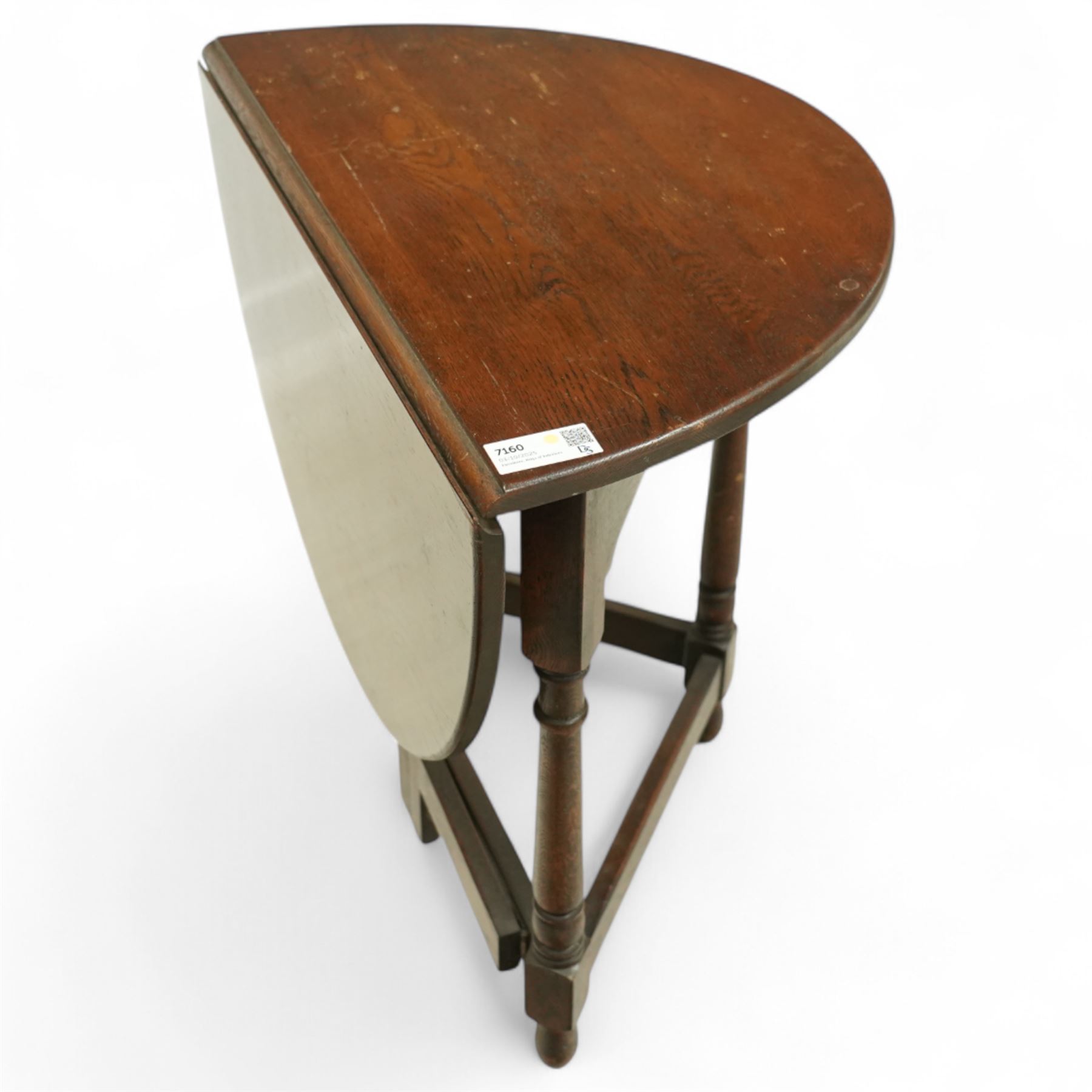 20th century oak drop-leaf table, of gateleg form with oval top, raised on turned legs and stretchers with twin gate supports