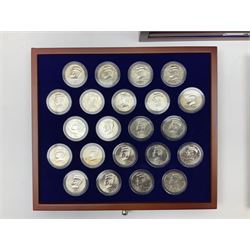 United States of America half dollar coins from 'The John F. Kennedy Uncirculated U.S. Half-Dollar Collection', housed in a display cabinet
