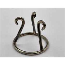 Modern silver limited edition Easter egg, no. 70/500, the gilt openwork body decorated with cascading bluebells and hinged cover with pierced circular panel set with a single faceted purple stone, opening to reveal a gilt interior, upon silver stand with three scrolling pad feet, each hallmarked St James House Company, London 1981, height including stand 8cm