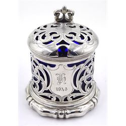Victorian silver mustard pot, of drum form with scroll handle and scrolling foliate pierced decoration, the body with cartouche engraved with initial and date of 1843, upon an ogee baton and ball foot, hallmarked Henry Wilkinson & Co, Sheffield 1849, with accompanying blue glass liner, H8cm, approximate silver weight 3.57 ozt (111.3 grams)

