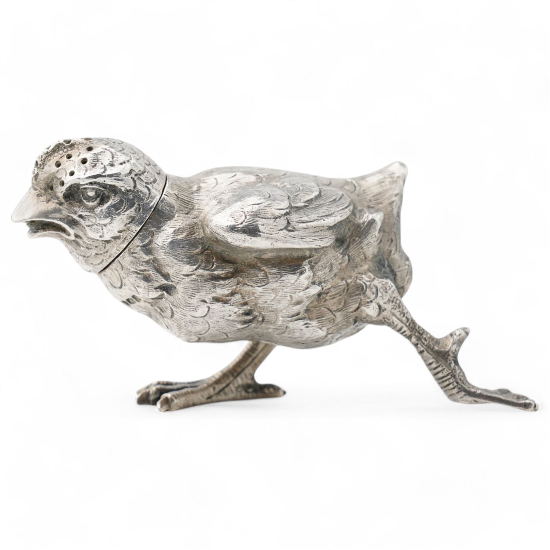   German silver novelty pepper pot in the form of a running chick, realistically modelled L8cm London 1922 Maker Berthold Hermann Muller and a silver jockeys cap caddy spoon Sheffield 1954 Maker Atkin Bros (2)