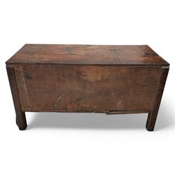Large late 17th Century oak coffer, the hinged lid with twin rear strap hinges above a plain front with inset brass escutcheon, raised on square supports with pegged joinery and displaying pronounced grain figuring to the single front board