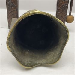 Chinese brass temple bell, decorated in high relief with a a dragon chasing a flaming pearl, within a carved floral hardwood stand, H36cm