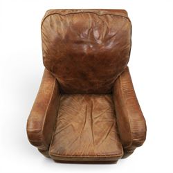 Art Deco style brown leather reclining armchair, scrolled arms with brass studded trim, reclining foot rest and back, fixed back and loose seat cushion,