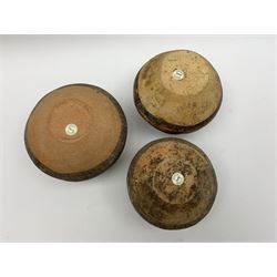 Three Chinese Neolithic pottery vessels, each with twin loop handles to the shoulder and painted geometric banded decoration to the body, all bearing labels for Eskenazi London, tallest H14cm